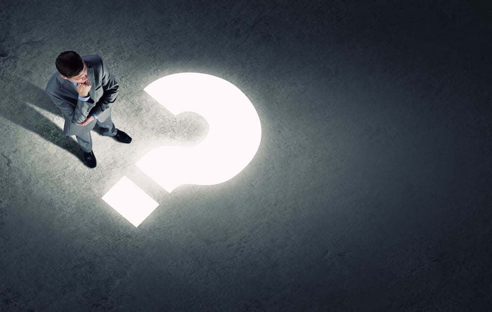 Top view of businessman looking at question mark on floor